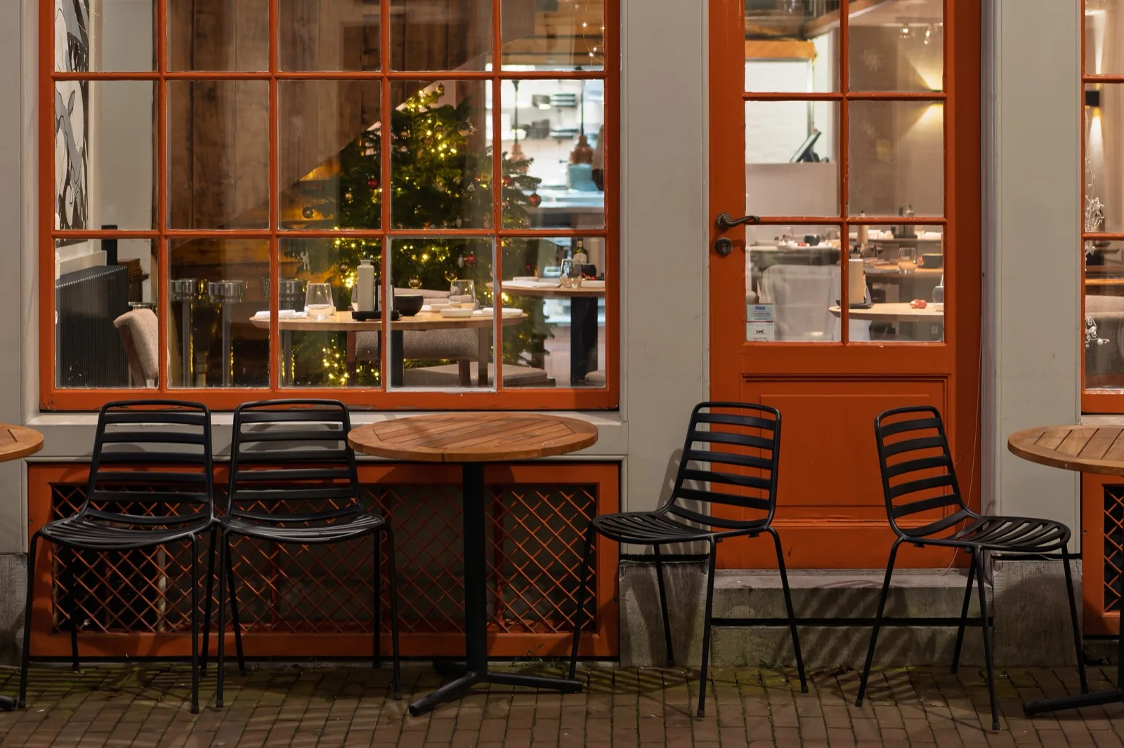 A bistro storefront with tables and chairs on the pavement
