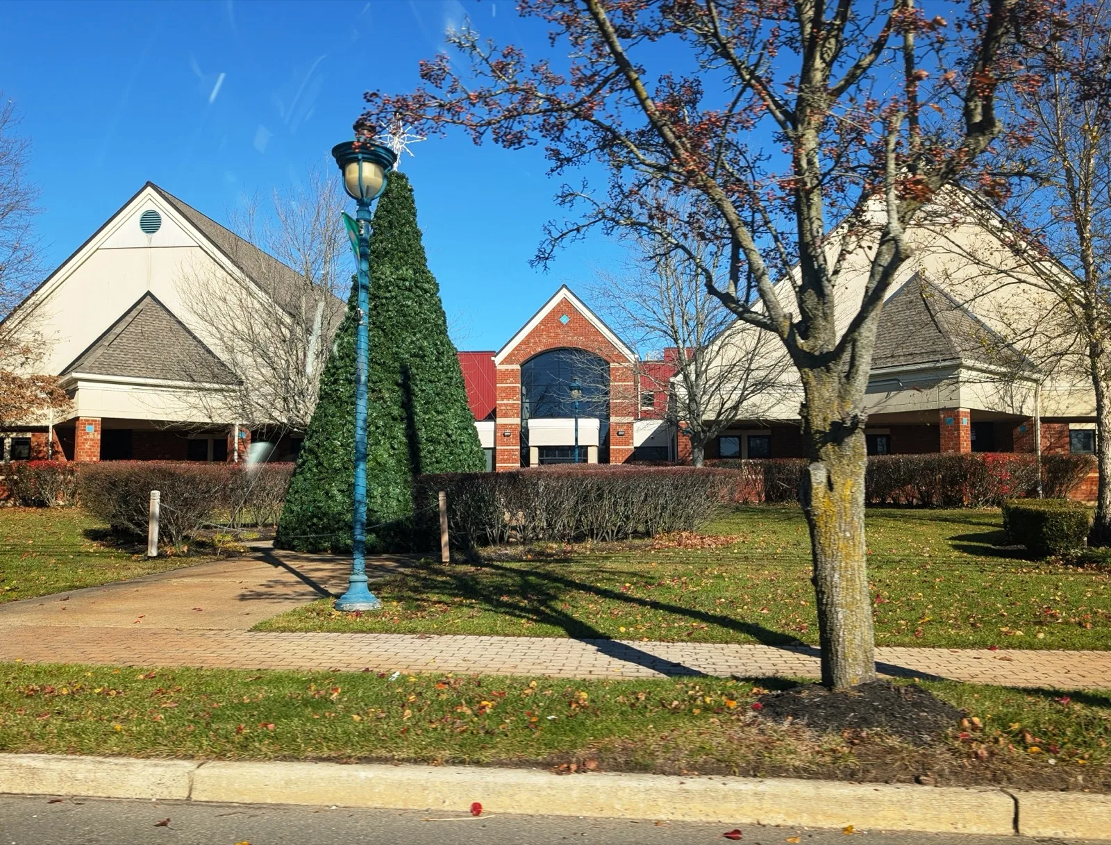 The Stafford Township Municipal Complex in Manahawkin, a brick and tan building behind a lawn and trees