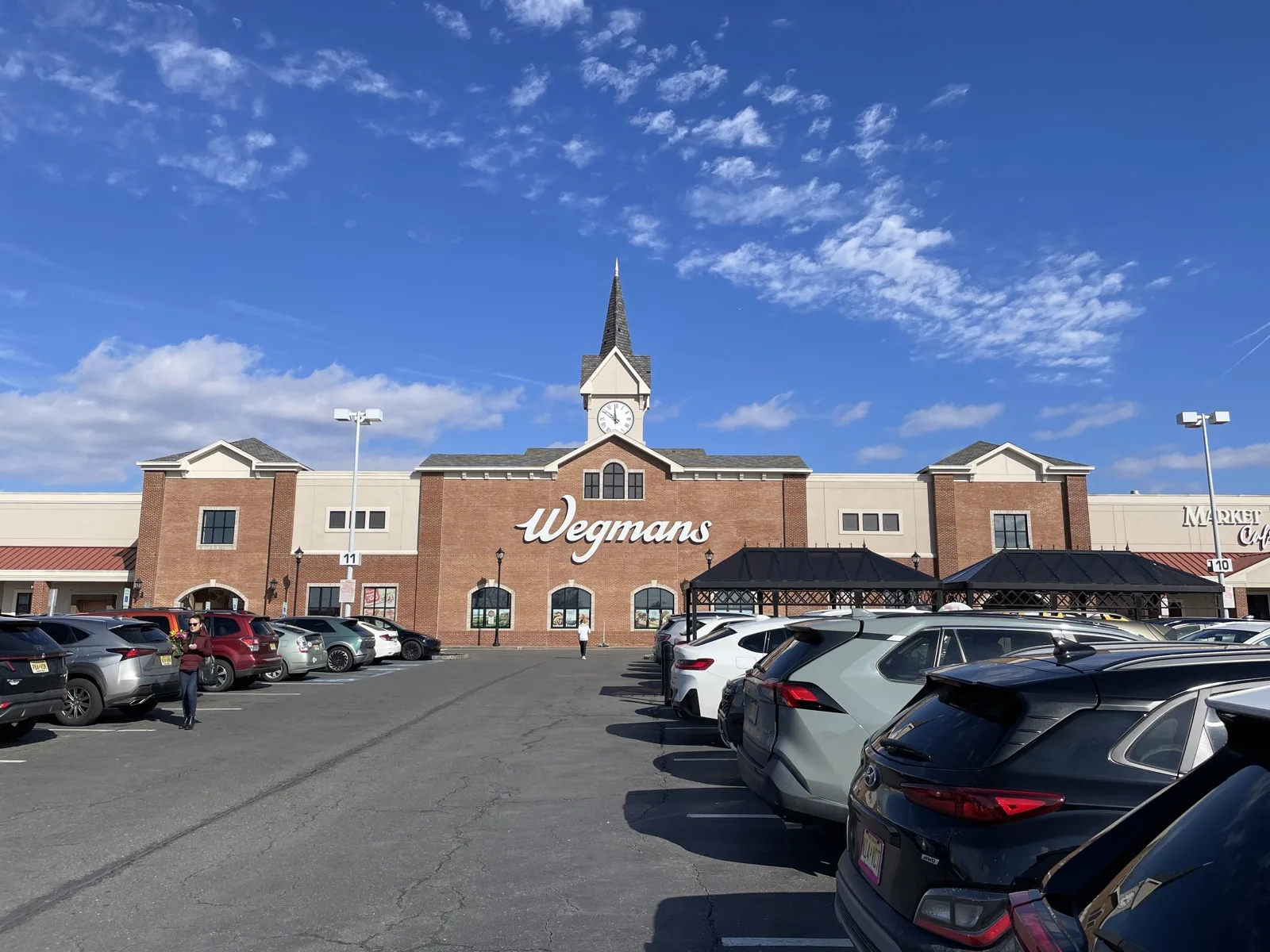 The Wegmans store in Cherry Hill, a brick building with a clock tower, an anchor of Market Place at Garden State Park
