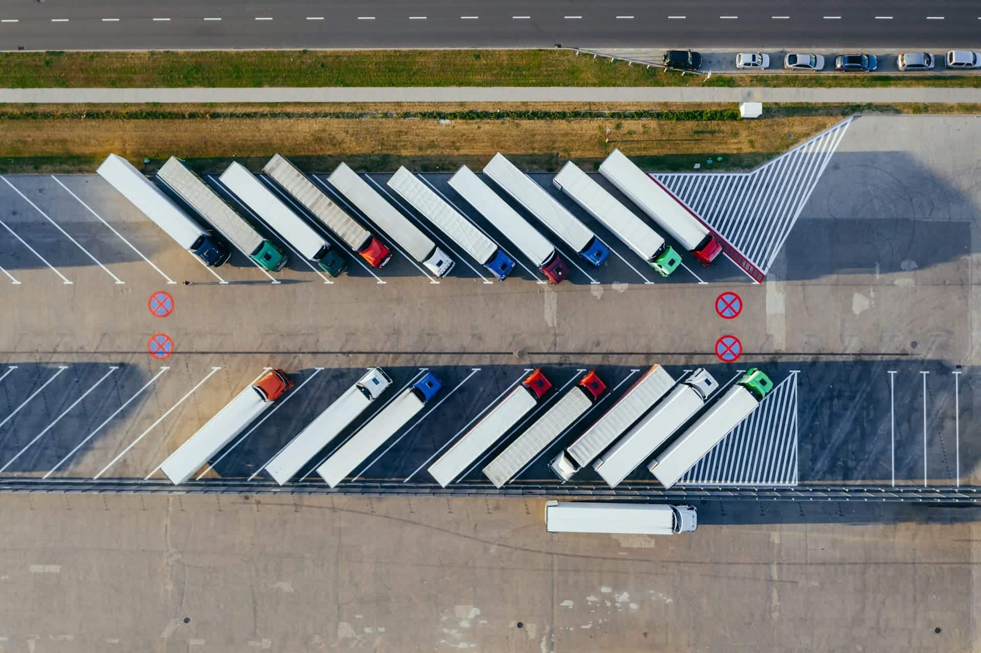 Tractor trailers parked in rows at an industrial outdoor storage yard